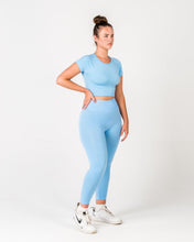 Load image into Gallery viewer, A woman wearing Sky Blue Top of True Form UK, a Gym Clothing brand.

