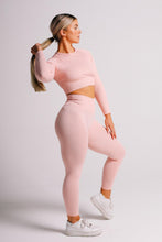 Load image into Gallery viewer, Lady standing with holding her hair wearing TrueForm Pink Ribbed Leggings and Top
