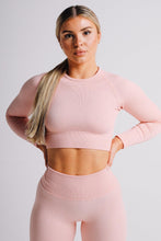 Load image into Gallery viewer, A model standing wearing true form baby pink ribbed long sleeve top
