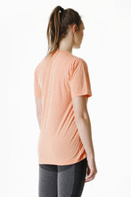 Load image into Gallery viewer, A women wearing True Form UK Unisex Peach Statement T-shirt of gym clothing
