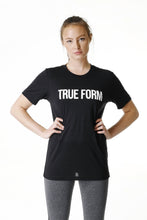 Load image into Gallery viewer, A woman wearing True form Unisex Black Tshirt in UK
