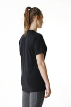 Load image into Gallery viewer, A woman facing sideward wearing True form Unisex Black Statement T-shirt

