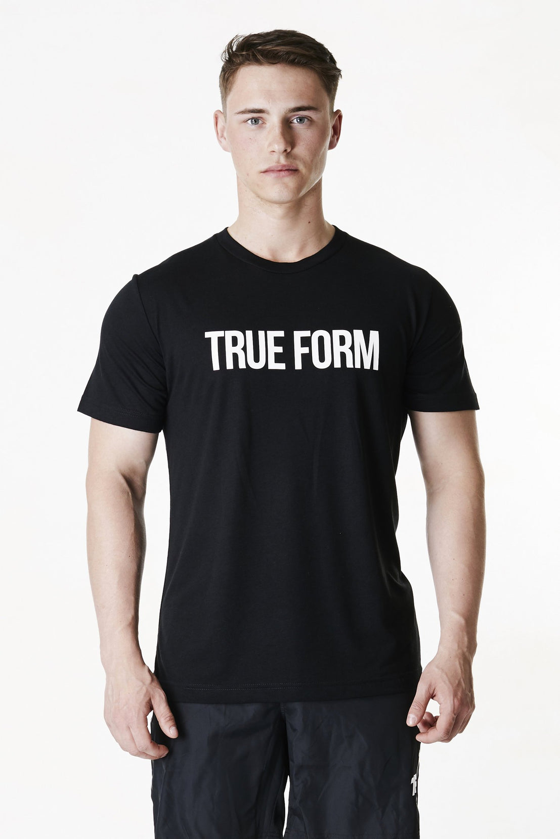 A man wearing True form Unisex Black Tshirt in UK