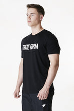Load image into Gallery viewer, A man facing sideward wearing True form Unisex Black Statement T-shirt
