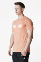 Load image into Gallery viewer, A man wearing true form Peach Statement T-shirt
